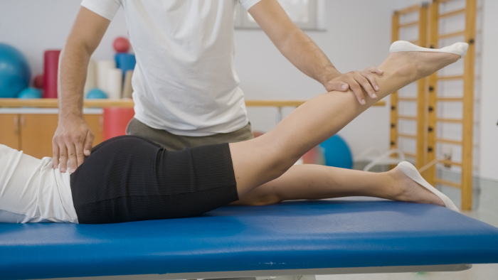 Biokinesiology being applied to patient's leg